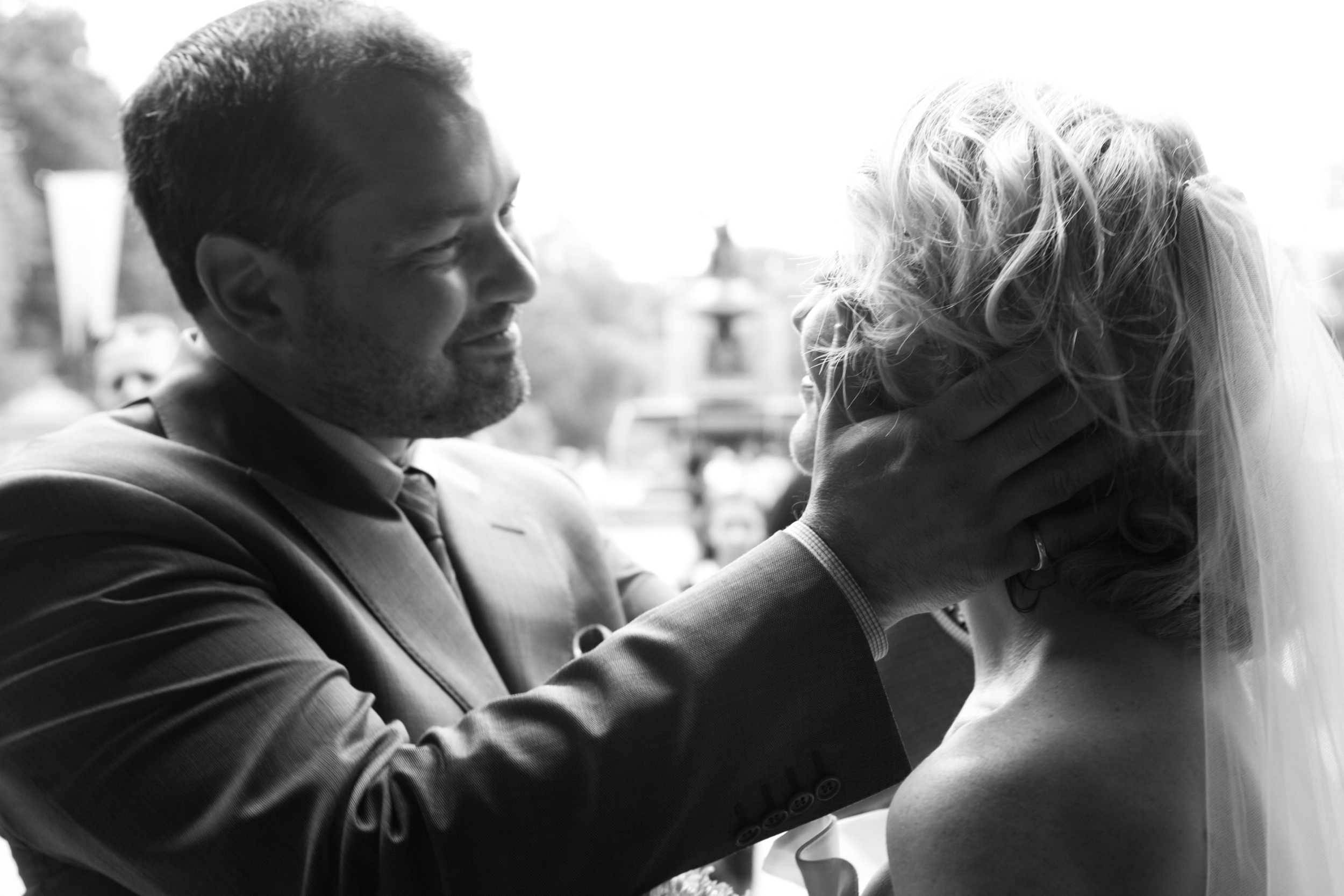 A tender moment between two people, with one gently touching the other's face.