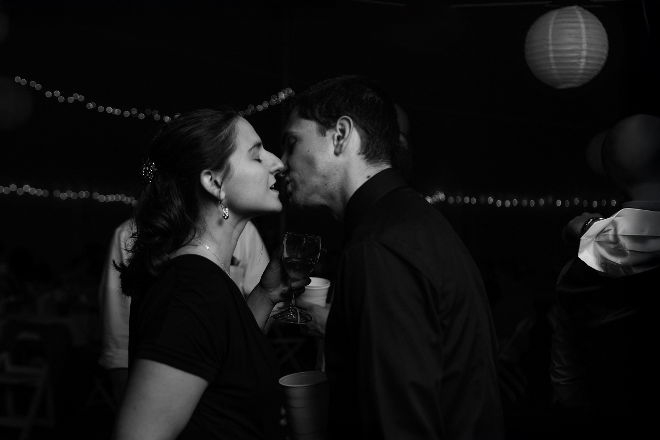 Couple sharing a tender moment in a dimly lit setting.