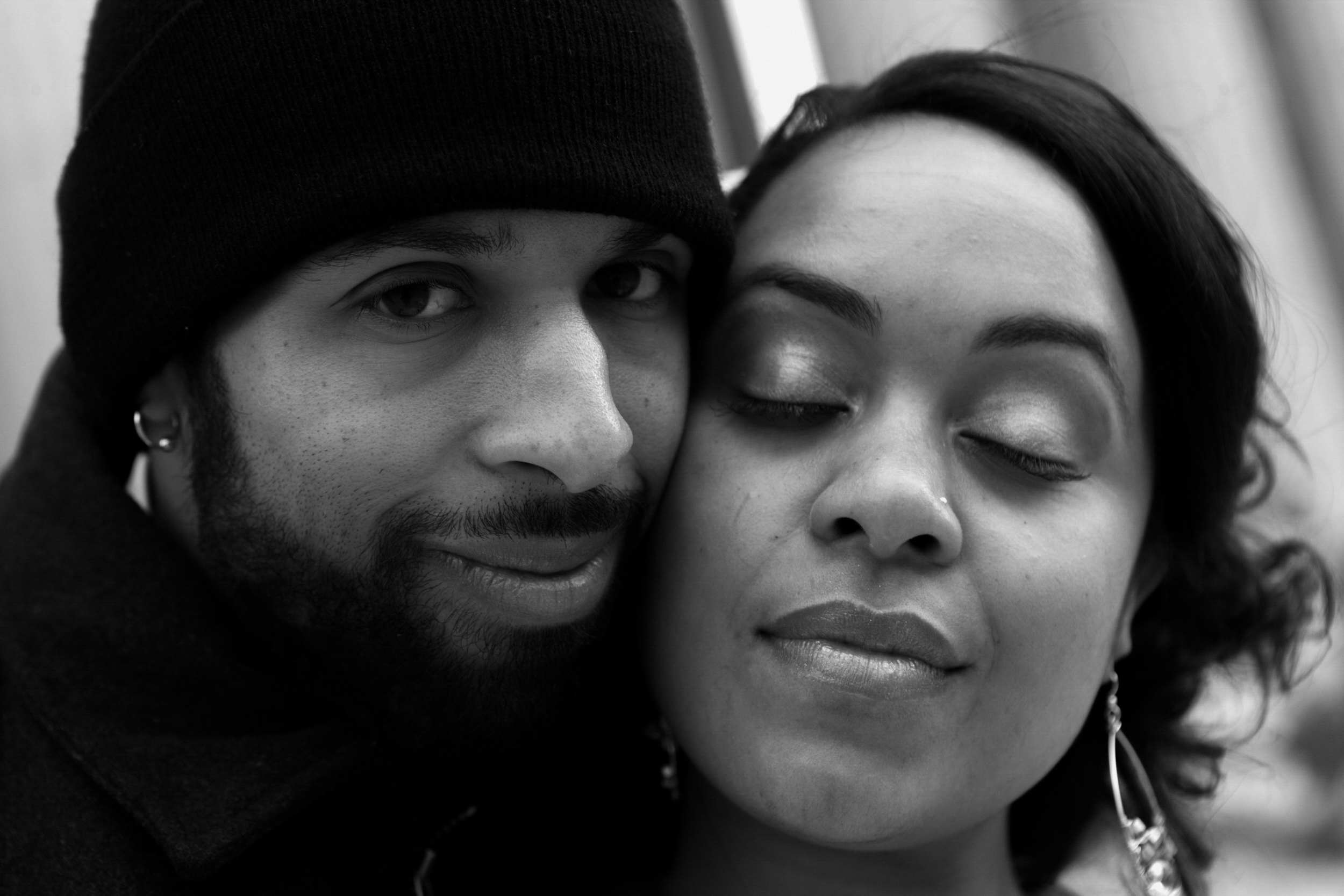 A close-up black and white photo of a couple with peaceful expressions.