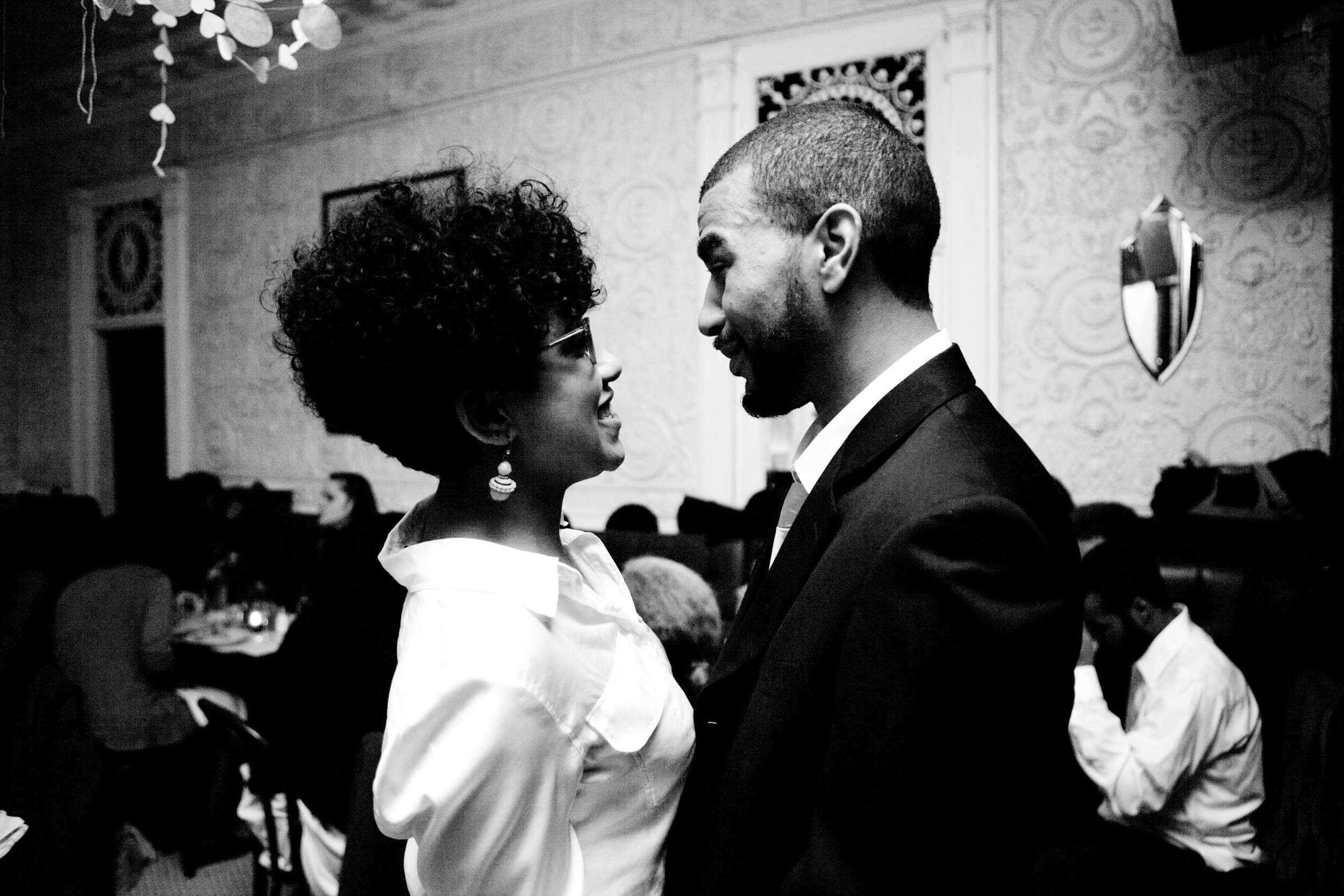 A joyful couple sharing a loving moment at a formal event.