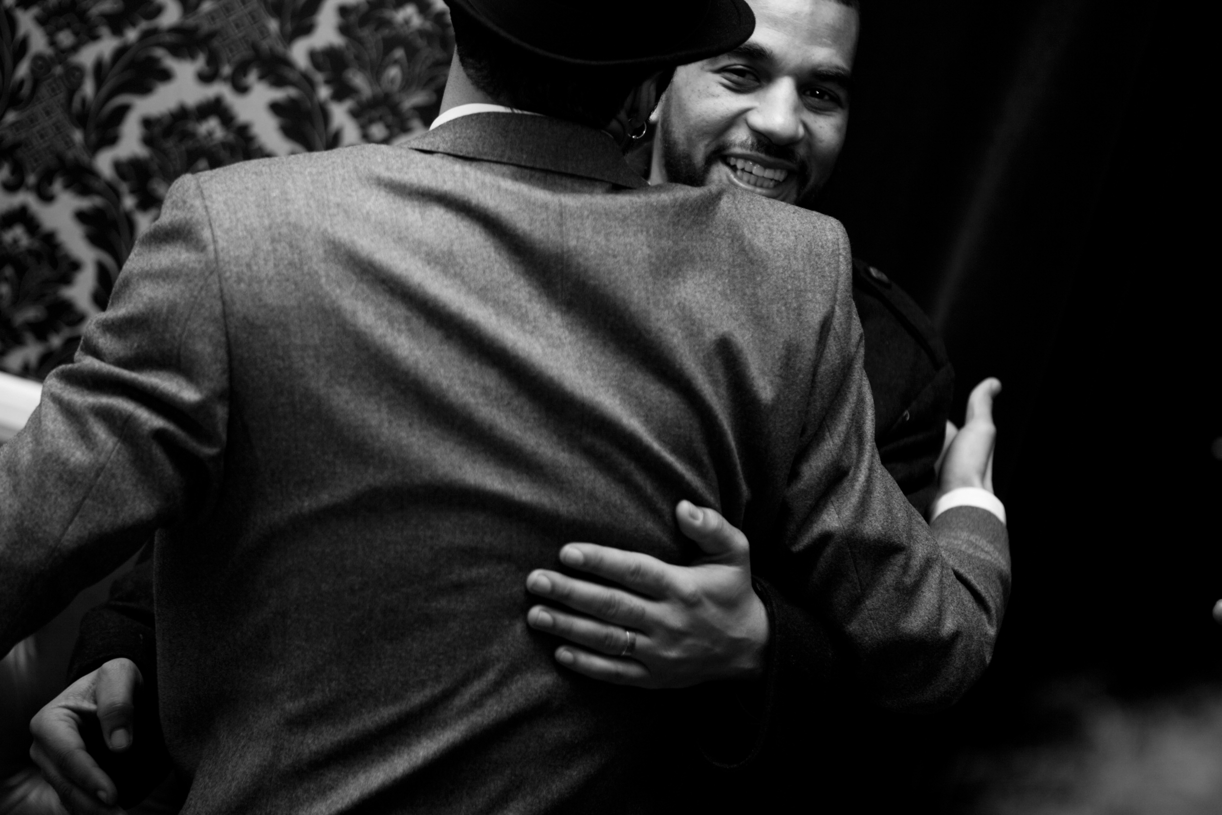 Two men warmly embrace in a heartfelt hug.