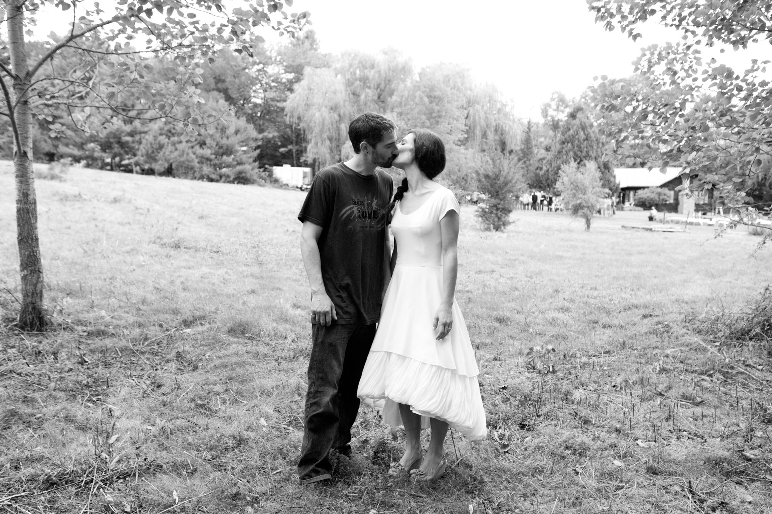 Couple sharing a tender moment outdoors in black and white.