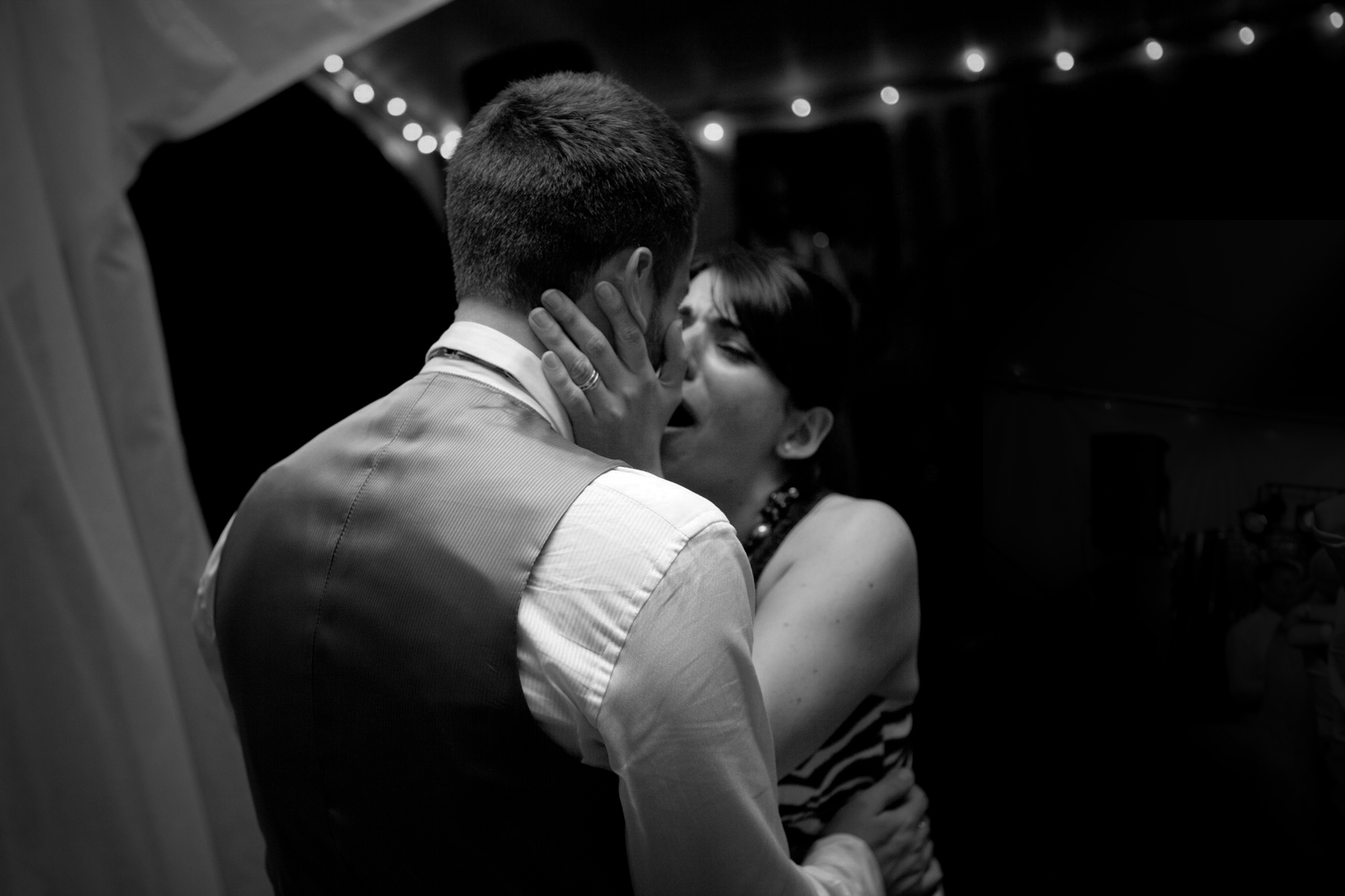 Couple sharing a tender dance in black and white.