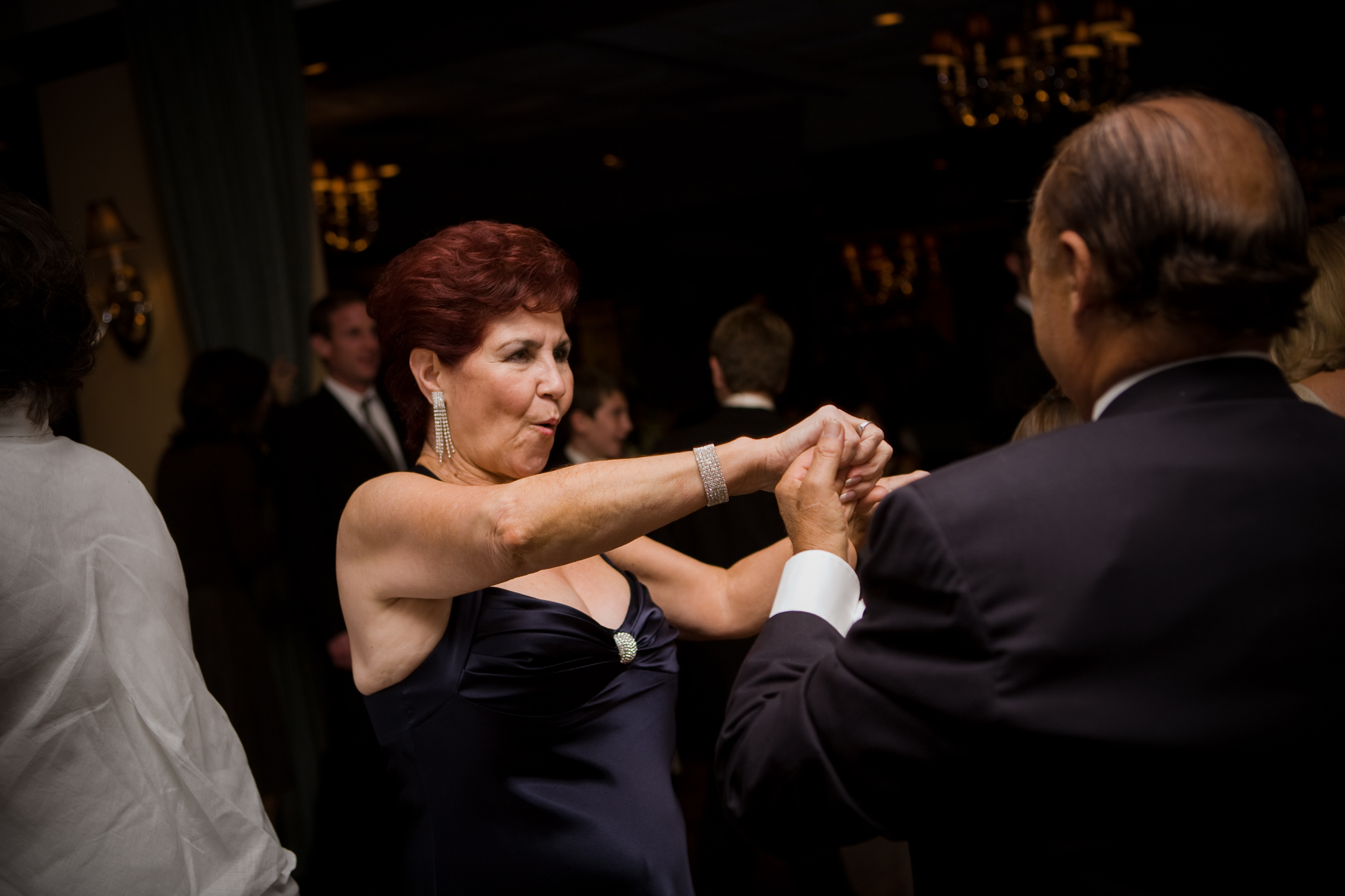 Elegant couple dancing closely at a formal event.