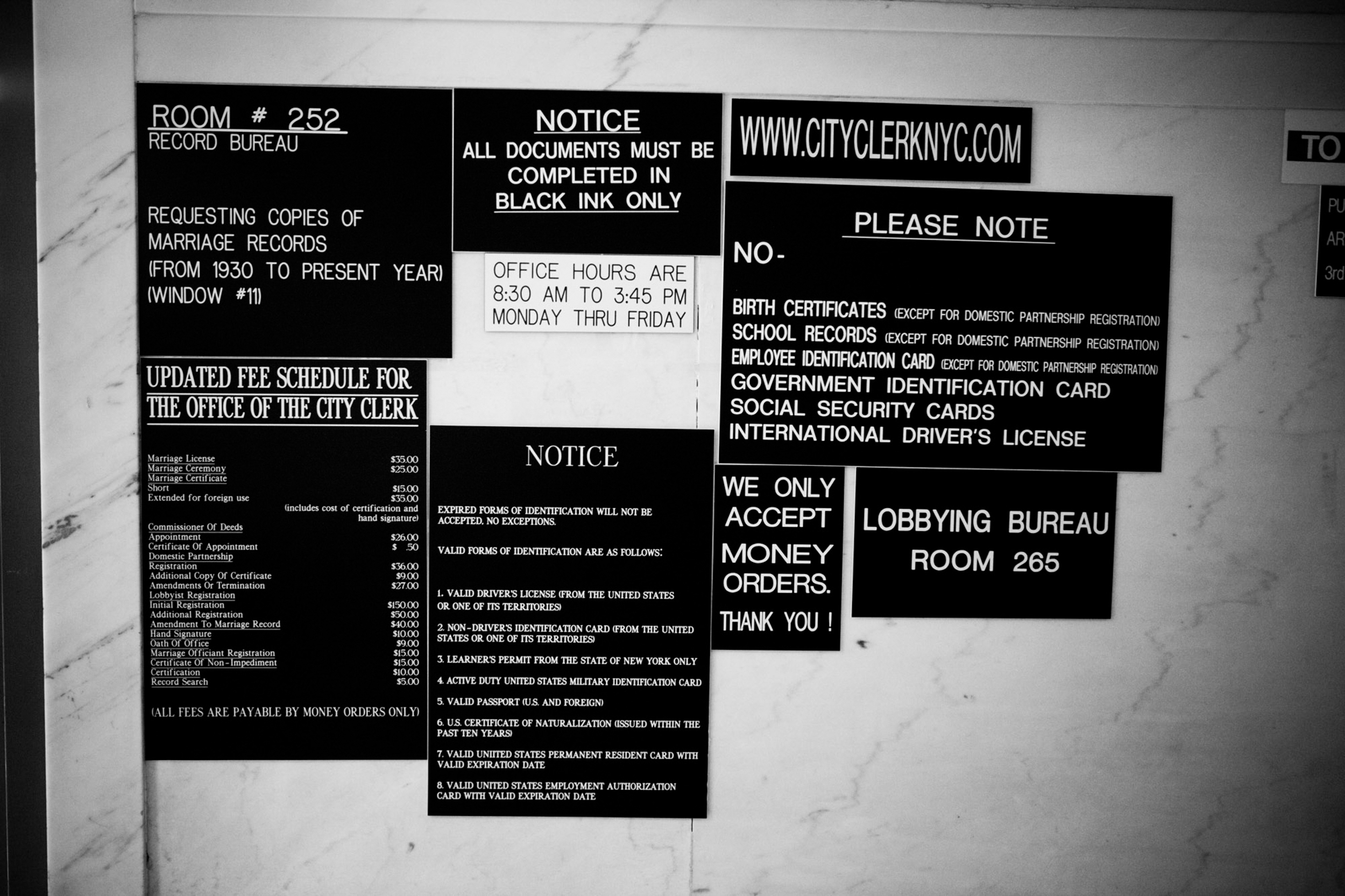 Black and white signs with various notices and instructions.