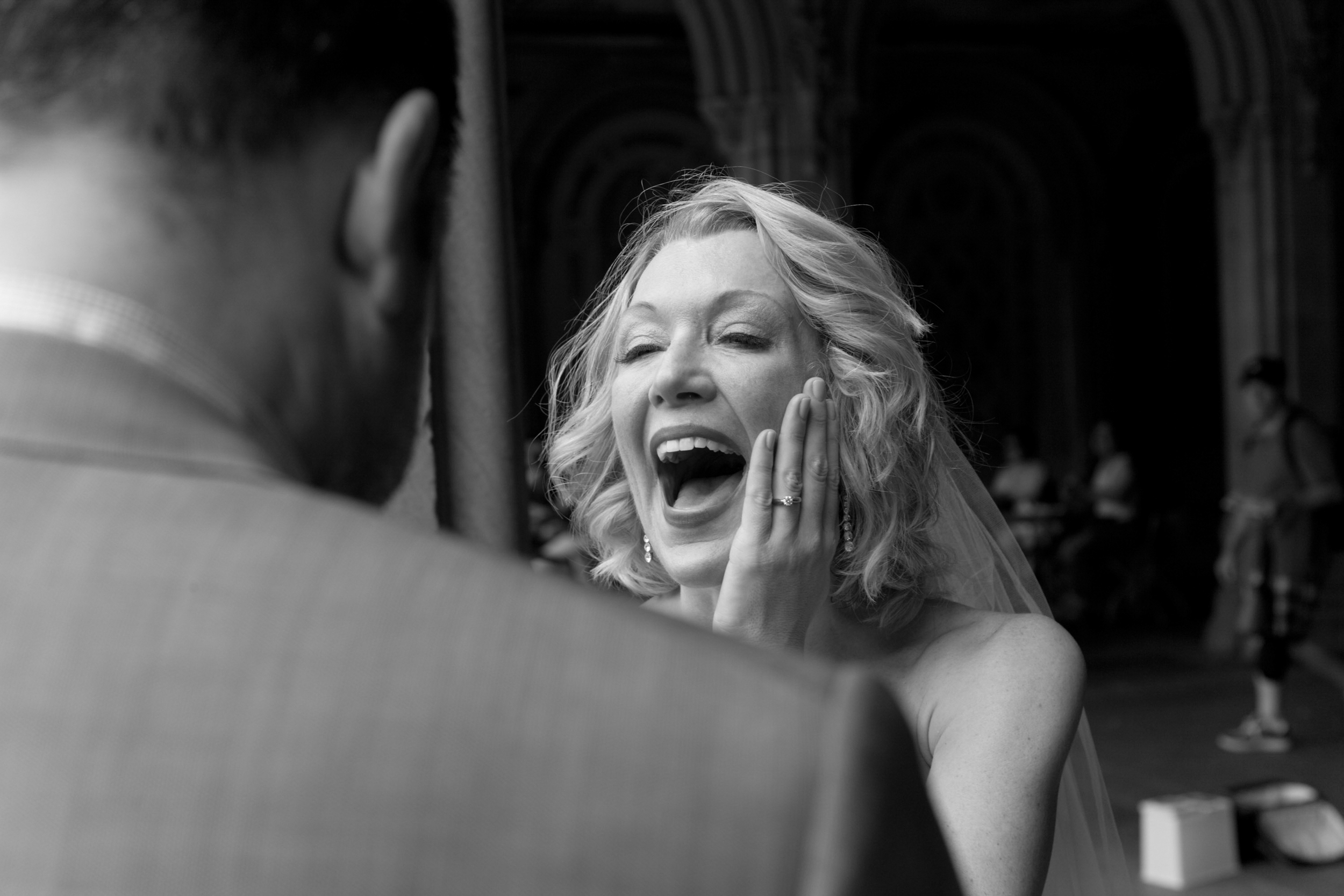 Woman laughing joyfully while talking on the phone.