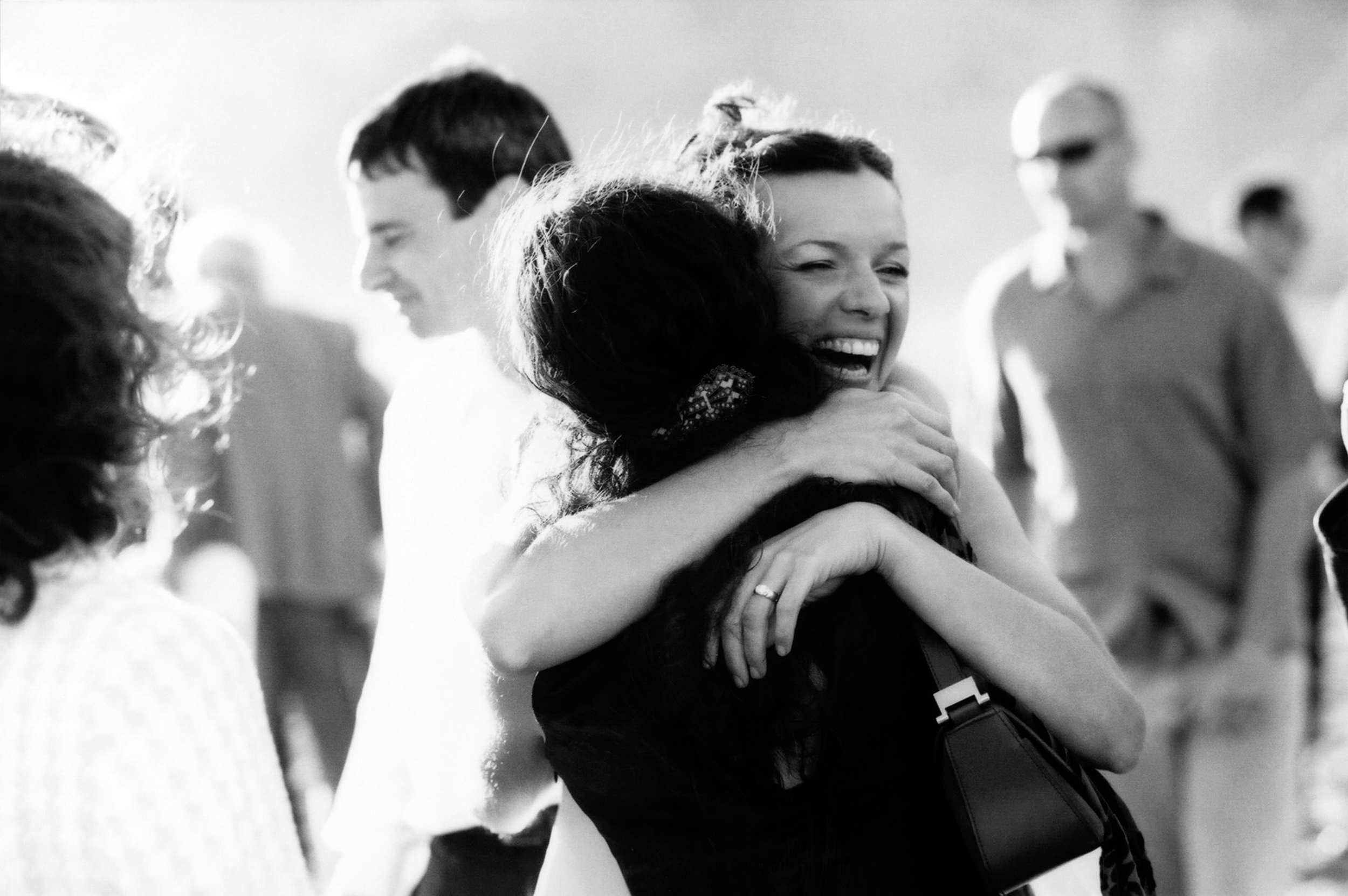 Two people warmly hugging in a joyful moment.